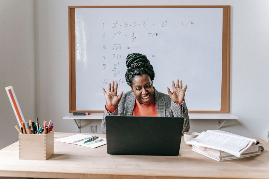 An instructor greeting her class on a video call